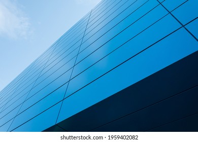 Geometric colored building facade elements with planes, lines and corners with light flare and reflections for an abstract background and texture of white, blue, gray colors. Place for text