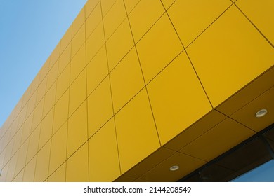Geometric colored building facade elements with planes, lines and corners with light flare and reflections for an abstract background and texture of white, blue, gray colors. Place for text