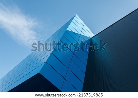 Geometric colored building facade elements with planes, lines and corners with light flare and reflections for an abstract background and texture of white, blue, gray colors. Place for text