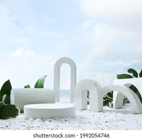 Geometric Concrete Podium On Tropical Beach With Flowers. Empty Showcase For Packaging Product Presentation Near Sea Or Ocean. Background For Cosmetic Products, Scene With Green Leaves And Sand. 