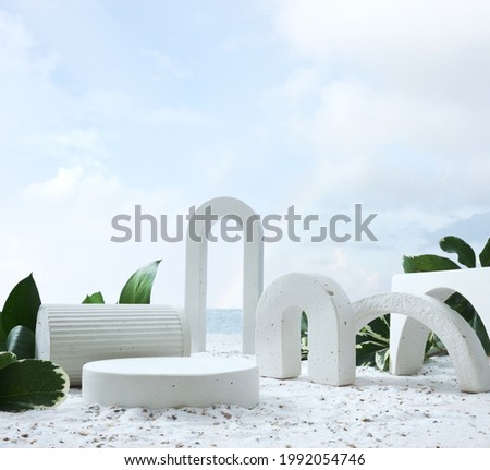 Geometric concrete podium on tropical beach with flowers. Empty showcase for packaging product presentation near sea or ocean. Background for cosmetic products, scene with green leaves and sand. 
