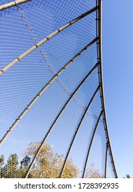 Geometric design element chain link baseball backstop fence and blue sky