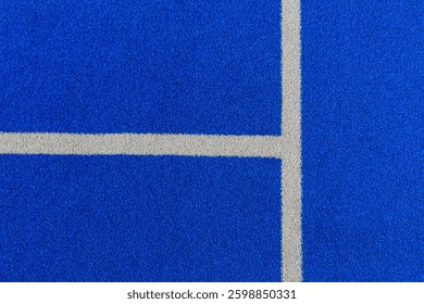 Geometric details of padel tennis court lines on blue textured surface