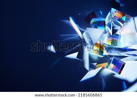 Geometric figures prisms with light diffraction of spectrum colors and reflection with trendy light