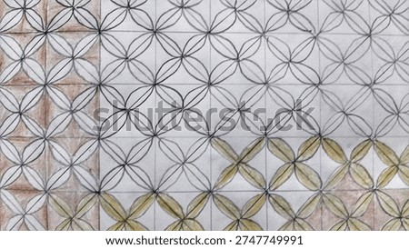 
​Hand-drawn geometric floral pattern on grid paper with pencil and colored accents. Intricate repetitive petal design, creative sketch, and artistic background for textile or wallpaper inspiration.