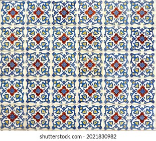 Geometric floral tile mosaic in blues and reds. Typical of the designs and patterns typically found on the facade of traditional Chinese Peranakan shop houses. 