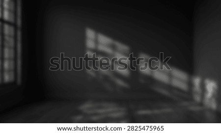 Geometric light patterns created by sunlight streaming through a window onto a dark wall, creating an abstract visual effect.