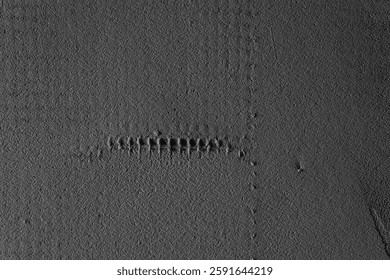 Geometric lines and patterns appear on a flat surface, showcasing geological features.