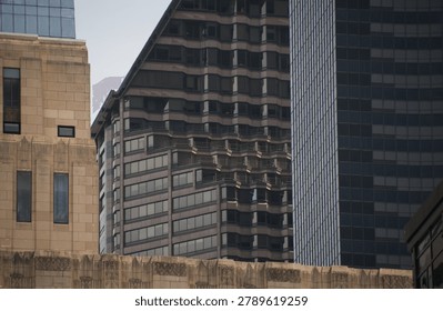 Geometric lines and repeating forms define a cluster of modern high-rise buildings in downtown Seattle. The image focuses on architectural patterns and urban density within the city's business district.