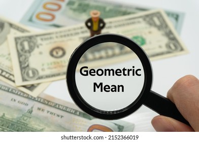 Geometric Mean.Magnifying glass showing the words.Background of banknotes and coins.basic concepts of finance.Business theme.Financial terms. - Shutterstock ID 2152366019