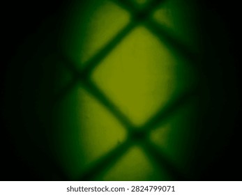 Geometric mesh shadow pattern with moody green lighting and dark vignette