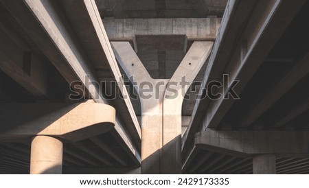 Geometric pattern background of concrete foundation structure of Elevated Expressway with light and shadow on surface, low angle view with copy space