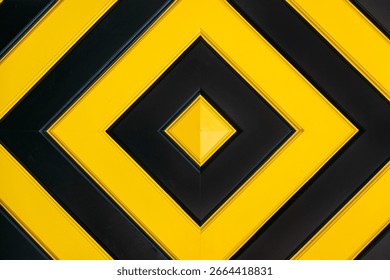 Geometric pattern featuring alternating black and yellow diamond shapes in a symmetrical layout. Visual abstraction, color theory, modern design, geometric minimalism