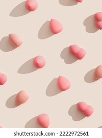 Geometric pattern from makeup sponges for foundation cream on beige background with dark shadows. Beauty blender pink and beige. Fashion Flat lay cosmetic sponge, top view graphic layout, vertical - Shutterstock ID 2222972561