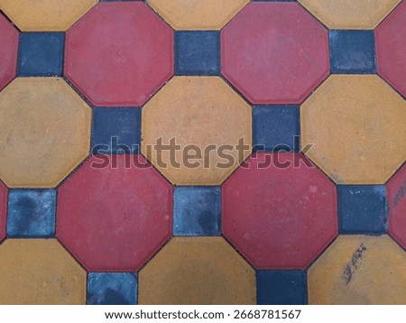 Geometric pattern of octagonal paving stones in red, yellow, and blue