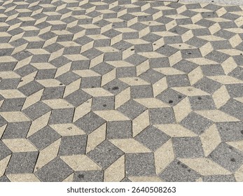Geometric patterned stone pavement with 3d optical illusion in urban setting.