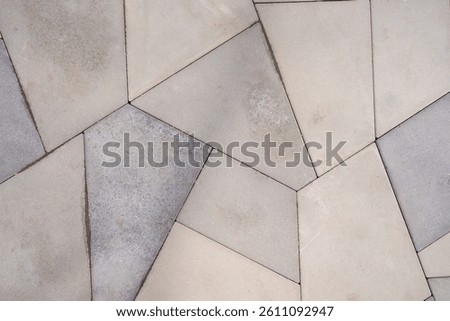 Geometric Paver Pattern, A close-up of a geometric paver pattern featuring polygonal tiles in neutral tones, creating a modern and stylish outdoor or indoor flooring design
