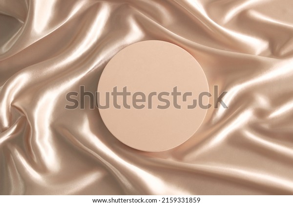 Geometric\
platform podium on pastel wave silk satin fabric background. Blank\
minimal cylinder form mock up background for beauty cosmetic\
product presentation. Top view, copy\
space