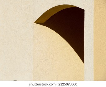 Geometric Shape Of Shadow In Concrete Archway Of Exterior Home Entrance Arched Triangle With Angles Black And Shades Of Yellow Horizontal Background Backdrop Or Wallpaper Room And Empty Space For Type