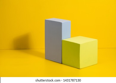 Geometric shapes in different colors on yellow background. Three-dimensional solid figures on colored paper. - Powered by Shutterstock