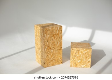 Geometric shapes from pressed OSB wood on a white background in sunlight with shadows. Rectangular and square shape made of wood panels. - Shutterstock ID 2094527596