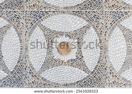 Geometric stone mosaic pattern close-up with intricate pebble detailing