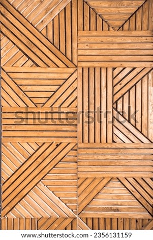 Geometric vertical wooden pattern on the wall of crisscrossing pine slats