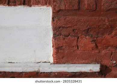 Geometric wall texture split between white painted surface and red brickwork at Northbrook Hall.