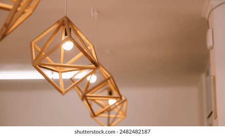 Geometric wooden pendant lights hang elegantly from the ceiling, casting a warm glow that adds a touch of modern sophistication to the minimalist interior. - Powered by Shutterstock