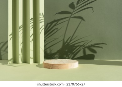 Geometric wooden podium on an abstract green background with a shadow of palm leaves. A scene with a geometric background. Backdrop for the product presentation. - Shutterstock ID 2170766727