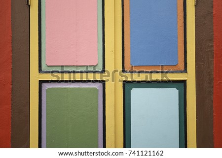 Geometrical background of the colorful window frame of a Chinese heritage Peranakan house in Little India, Singapore