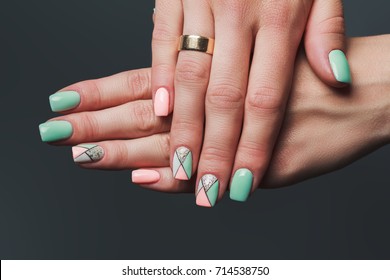 Geometry nail art design in pink   green colors dark background