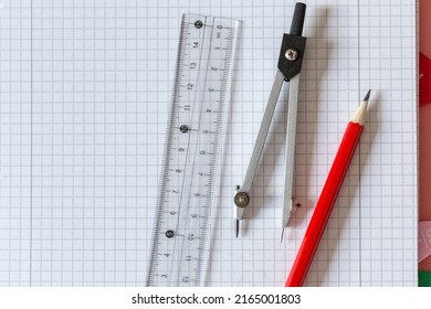 Geometry Set on open notebook.  Compass Drawing Tool, ruler, pencils for mathematical education. Math Drafting Dividers Tool, set for school, study. Back to school concept