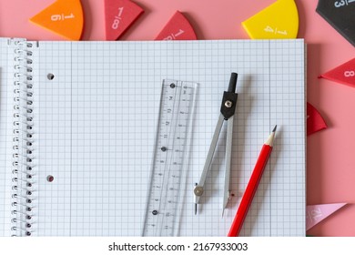 Geometry Set on open notebook.  Compass Drawing Tool, ruler, pencils, multicolored fractions for mathematical education. Math Drafting Dividers Tool, set for school, study. Back to school concept