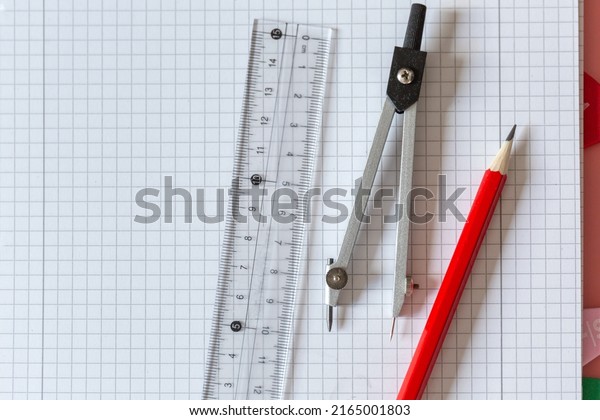 Geometry Set on
open notebook.  Compass Drawing Tool, ruler, pencils for
mathematical education. Math Drafting Dividers Tool, set for
school, study. Back to school
concept
