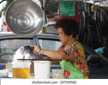 GEORGE TOWN, MALAYSIA - MAY 30: A Local Malay Woman Cooking At A Street Stall In George Town, Malaysia On The 30th May, 2014.