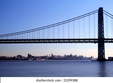 The George Washington Bridge Crosses Over The Hudson River From New Jersey To The Bronx, New York. New York Skyline In Background.