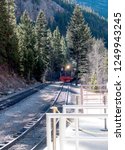 Georgetown Loop Train Engine Approaches Train Station in Mountains In Georgetown Colorado