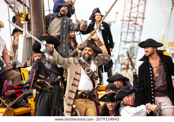 GEORGETOWN-CAYMAN ISLAND Jolly Roger Pirate\
boat. men  women dressed as pirate sword fighting,  Pirates Week\
2012 from 8 to 18 November on November 10 2017 in Georgetown Cayman\
Island.\
Caribbean