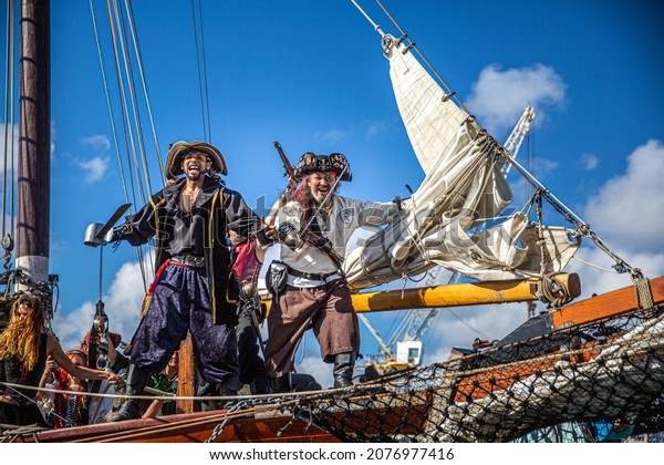 GEORGETOWN-CAYMAN ISLAND Pirate boat. men \
women dressed as pirate sword fighting, participate a the Pirates\
Week 2012 from 8 to 18 November on November 10 2017 in Georgetown\
Cayman Island.\
Caribbean