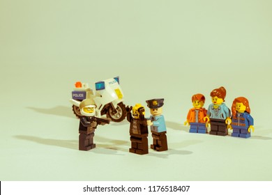 Georgia, USA - Sep 07, 2018: People or Family being mugged or robbery concept. Mini figures mugging up or arresting. Lego is a popular brand of mini figures. Lego Company is based in Denmark. - Shutterstock ID 1176518407