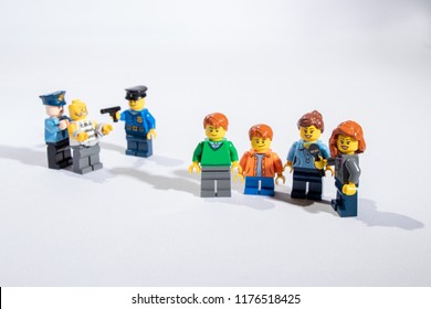 Georgia, USA - Sep 07, 2018: People or Family being mugged or robbery concept. Mini figures mugging up or arresting. Lego is a popular brand of mini figures. Lego Company is based in Denmark. - Shutterstock ID 1176518425