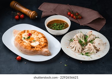 Georgian food khachapuri with egg, cherry tomato, butter and cheese, manti with meat and beef kharcho soup.