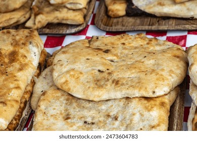 Georgian khachapuri set, flatbreads with cheese, spinach, mushrooms at street market. Golden brown appetizing khachapuri closeup