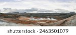 Námafjall Geothermal Area. Tourists in the distance, steaming fumaroles, boiling mud pots. Panorama of suggestive volcanic landscape. Sulfurous springs, solfataras and steam springs.