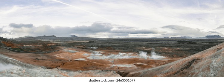 Námafjall Geothermal Area. Tourists in the distance, steaming fumaroles, boiling mud pots. Panorama of suggestive volcanic landscape. Sulfurous springs, solfataras and steam springs. - Powered by Shutterstock