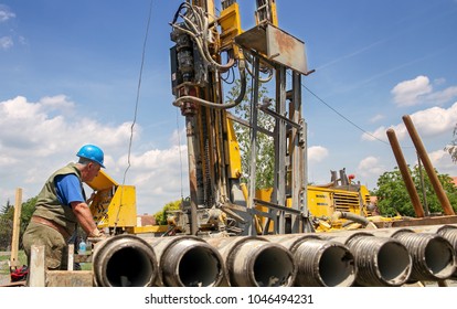 Geothermal Drilling Rig Workers. Drilling Geothermal Well For A Residential Geothermal Heat Pump. Workers On Drilling Rig.