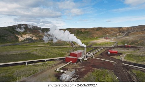 Geothermal power station in Icelandic landscape, steaming chimneys in the valley on a bright sunny day, aerial view. Energy, industry and sustainability concept. - Powered by Shutterstock