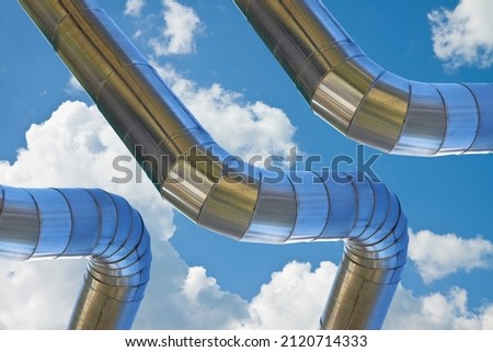 Geothermal stainless steel power pipe structure of a geothermal power station against a sky background