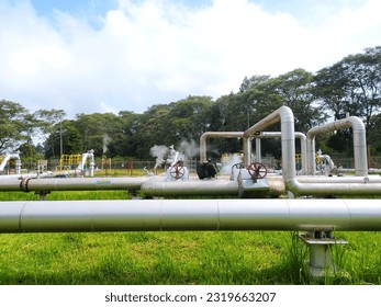 Geothermal steam energy factory, renewable green energy industry. Geothermal steam power plant, steam pipelines, alternative renewable energy in the world. kamojang, West Java, Indonesia.